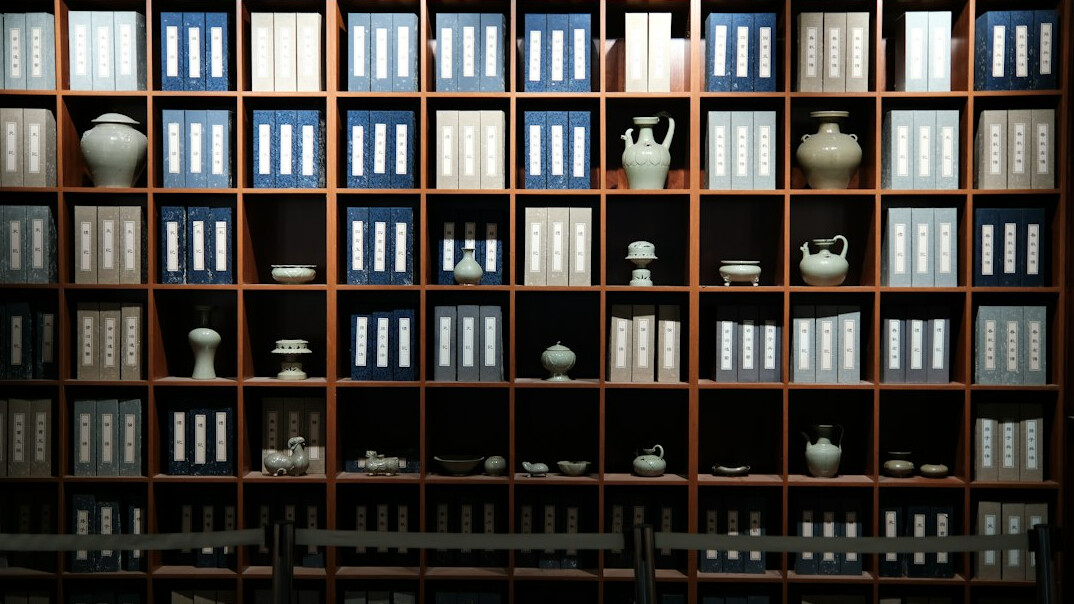 Rows of old archive shelves with document boxes