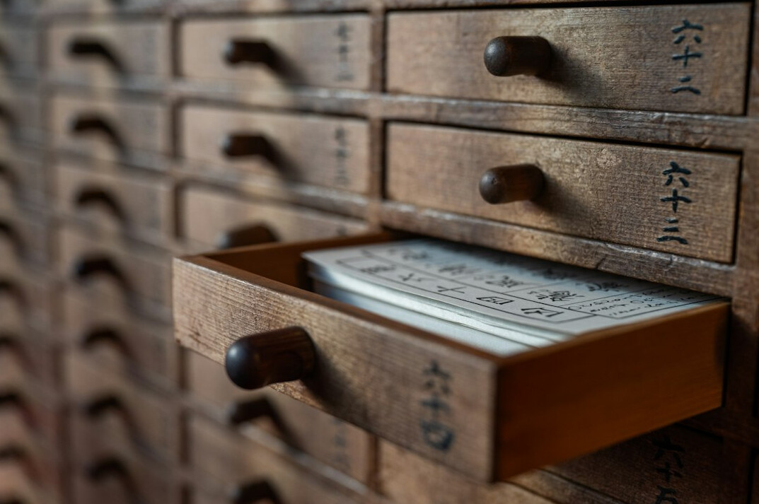 Open filing cabinet drawer full of documents