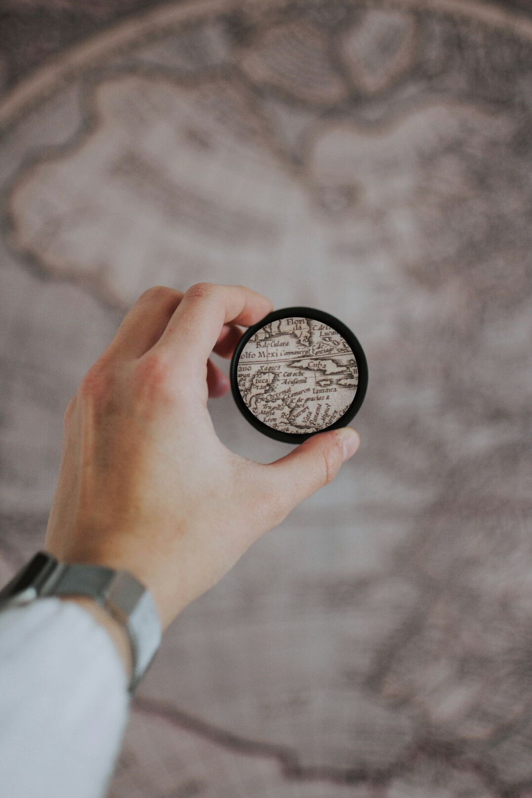 Magnifying glass resting on an old map